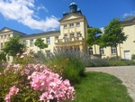 Fotografie krásného hotelu Zámeček - světle žlutá krásná budova a vpředu nádherné květiny - růže a levandule. Fotografie krásného hotelu Zámeček - světle žlutá krásná budova a vpředu nádherné květiny - růže a levandule.